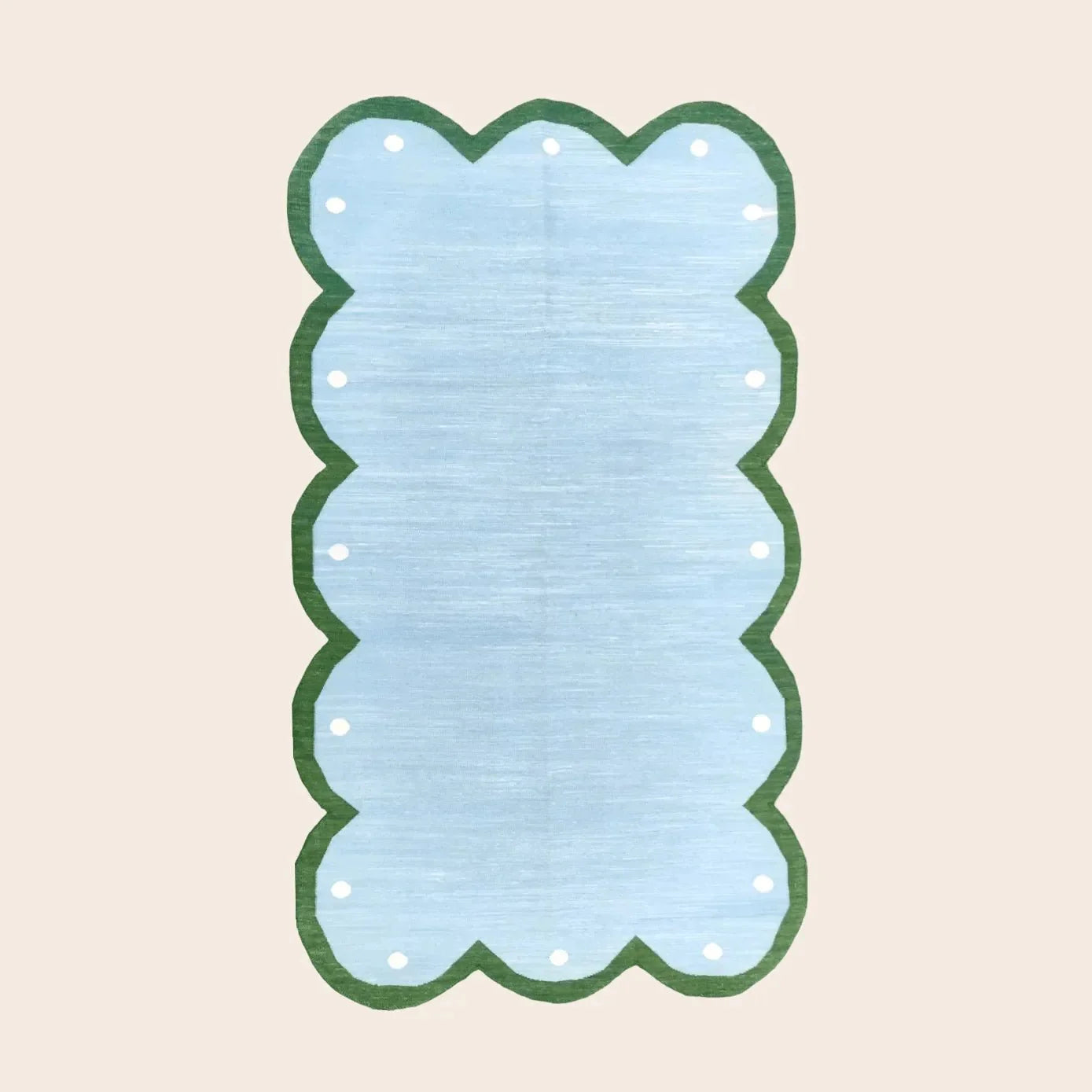 The "Handmade Scalloped Dotted Cotton Rug - 2' x 3'" features a charming scalloped edge and dotted pattern, offering a soft, durable, and stylish addition to any room.
