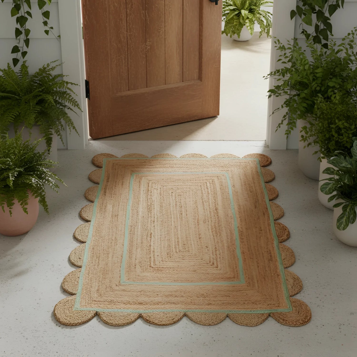 Turquoise trim scalloped jute rug at front door — natural braided jute with mint stripe and round scalloped edges, entryway