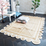 A beautifully designed handmade white scalloped jute area rug placed in a stylish living room. This elegant rug features intricate scalloped edges, enhancing the cozy and inviting atmosphere of the room. Perfect for dining room or living room, this area rug adds a touch of natural charm to any space.
