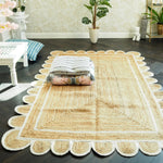 Stylish handmade white scalloped jute area rug placed in a bright living room. The rug enhances the dark wooden floor, adding warmth and texture. Perfect for dining rooms or as a centerpiece among rugs for living rooms.
