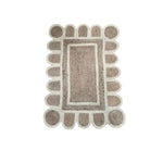 Top view of a Handmade White Trim Scalloped Jute Rug, measuring 2 x 3 feet. This area rug features a unique scalloped design with a natural jute texture, perfect for enhancing the decor of living room spaces.