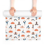 Hands unrolling Graceful Lotus mat from above, blue yoga figures and orange lotus