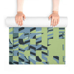 Hands unrolling Pixel Wave mat from above, textured green and blue mosaic