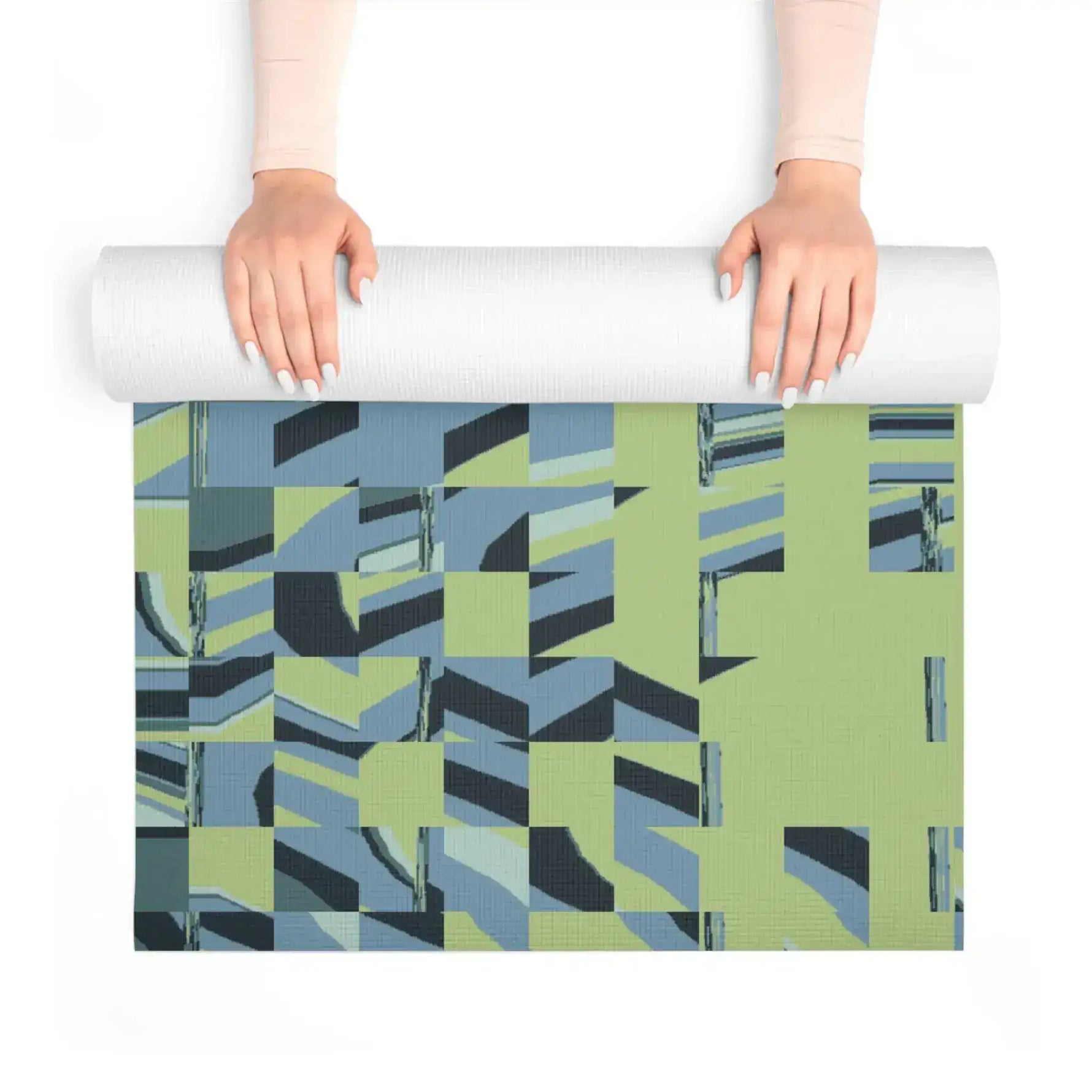 Hands unrolling Pixel Wave mat from above, textured green and blue mosaic