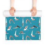 Hands unrolling the teal yoga mat from the top, full pose pattern shown