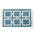Handwoven blue and white geometric cotton area rug with fringe detailing, perfect for a boho living room. This large area rug features a modern design, ideal for those seeking stylish and durable large area rugs for their living room.