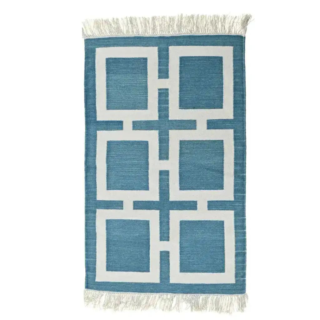 A beautifully handwoven blue and white geometric cotton area rug with fringes, perfect for adding a boho touch to your living room. This large area rug features a stylish pattern that enhances any living space, making it an ideal choice for those seeking cotton rugs or large area rugs for living room decor.
