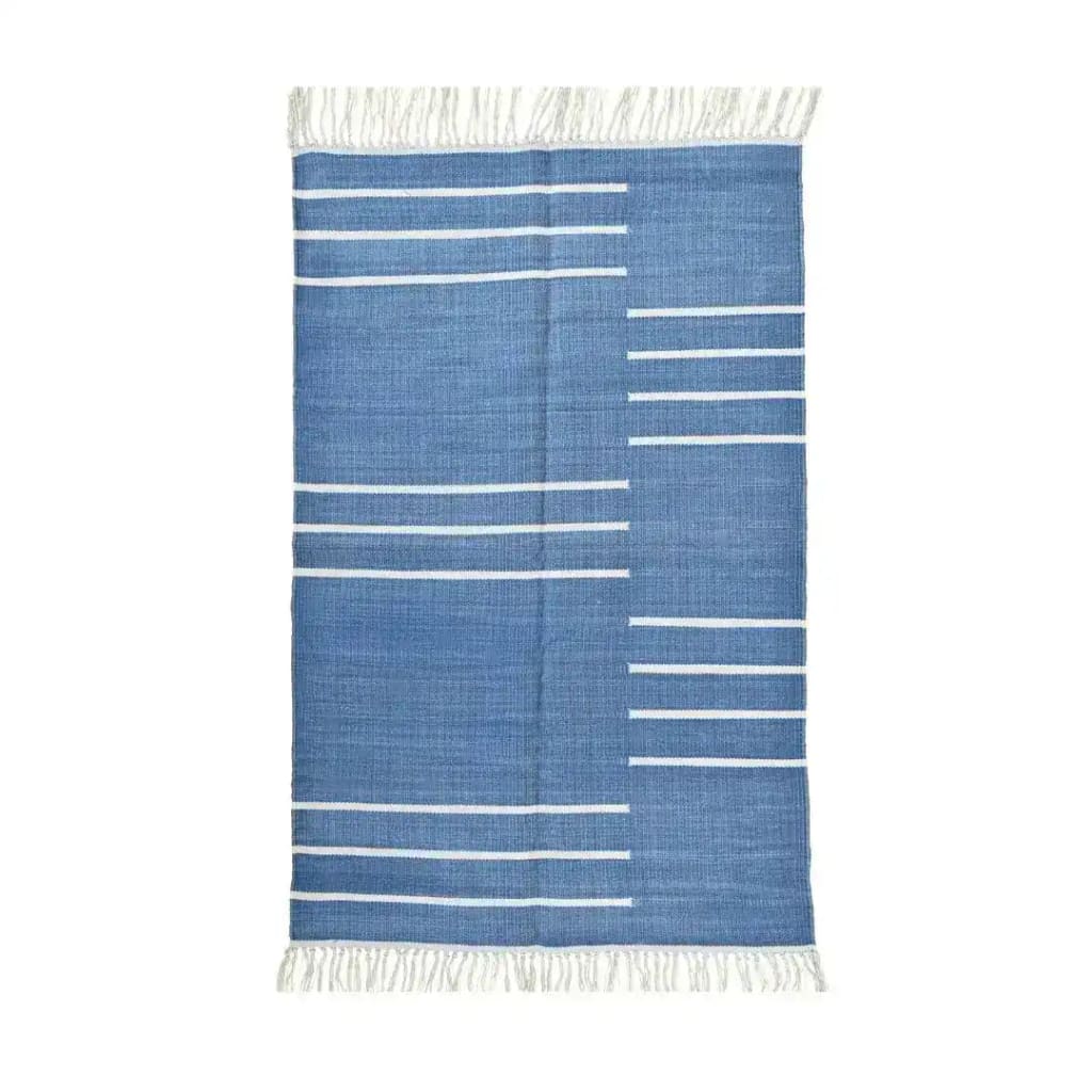 Handwoven blue and white minimalist cotton rug with fringes, ideal for a boho-inspired living room. This area rug features sleek white lines on a blue background, perfect for adding a modern touch to your space. Suitable for living room rugs 8x10, this cotton rug is both stylish and functional.