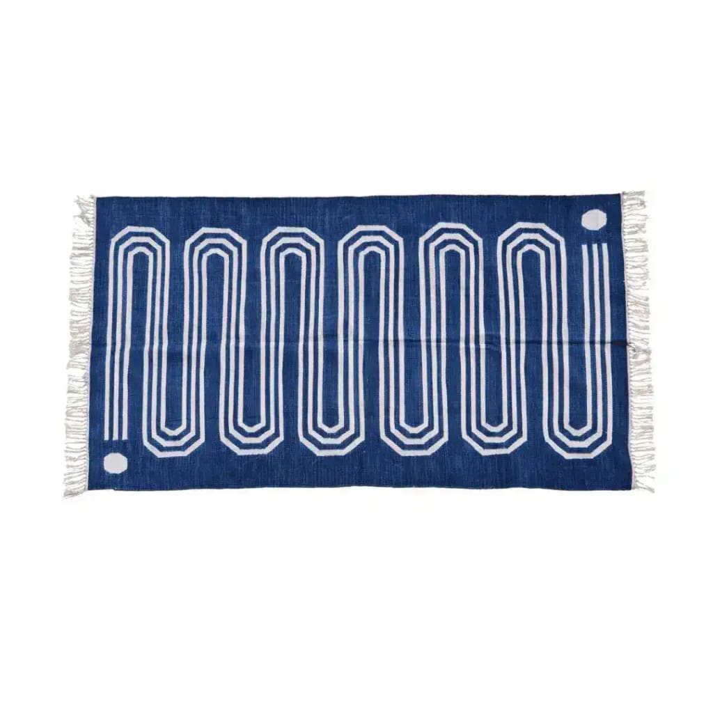 Handwoven blue and white cotton area rug with a snake-inspired pattern and fringes, perfect for adding a boho touch to your living room or bedroom decor.