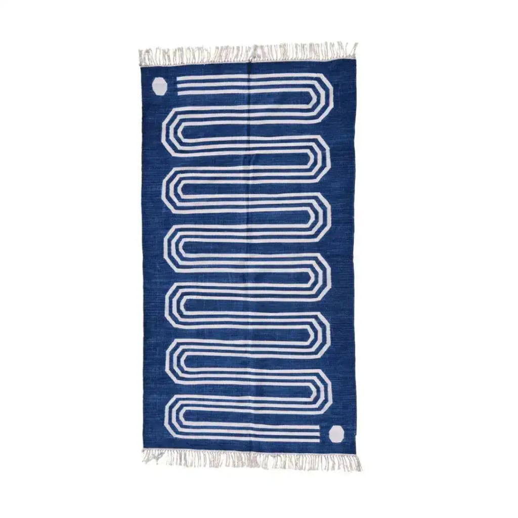 Handwoven blue and white snake inspired cotton area rug with fringes, ideal for living rooms and bedrooms. The boho rug features a bold geometric pattern, perfect as a statement piece for any space.