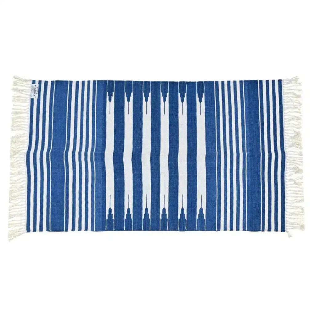 Handwoven blue and white striped cotton area rug with fringes, perfect for adding a boho touch to your dining room or bedroom. This stylish dining table rug is made from high-quality cotton, offering a cozy and chic vibe.