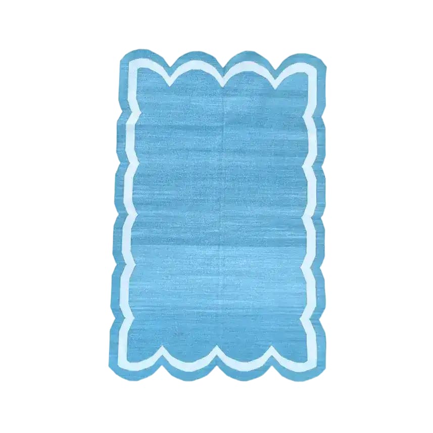 Handwoven blue and white scallop cotton area rug, perfect for dining rooms and living spaces. This boho rug adds a touch of elegance, making it an ideal dining table rug or a stylish addition to any living room.