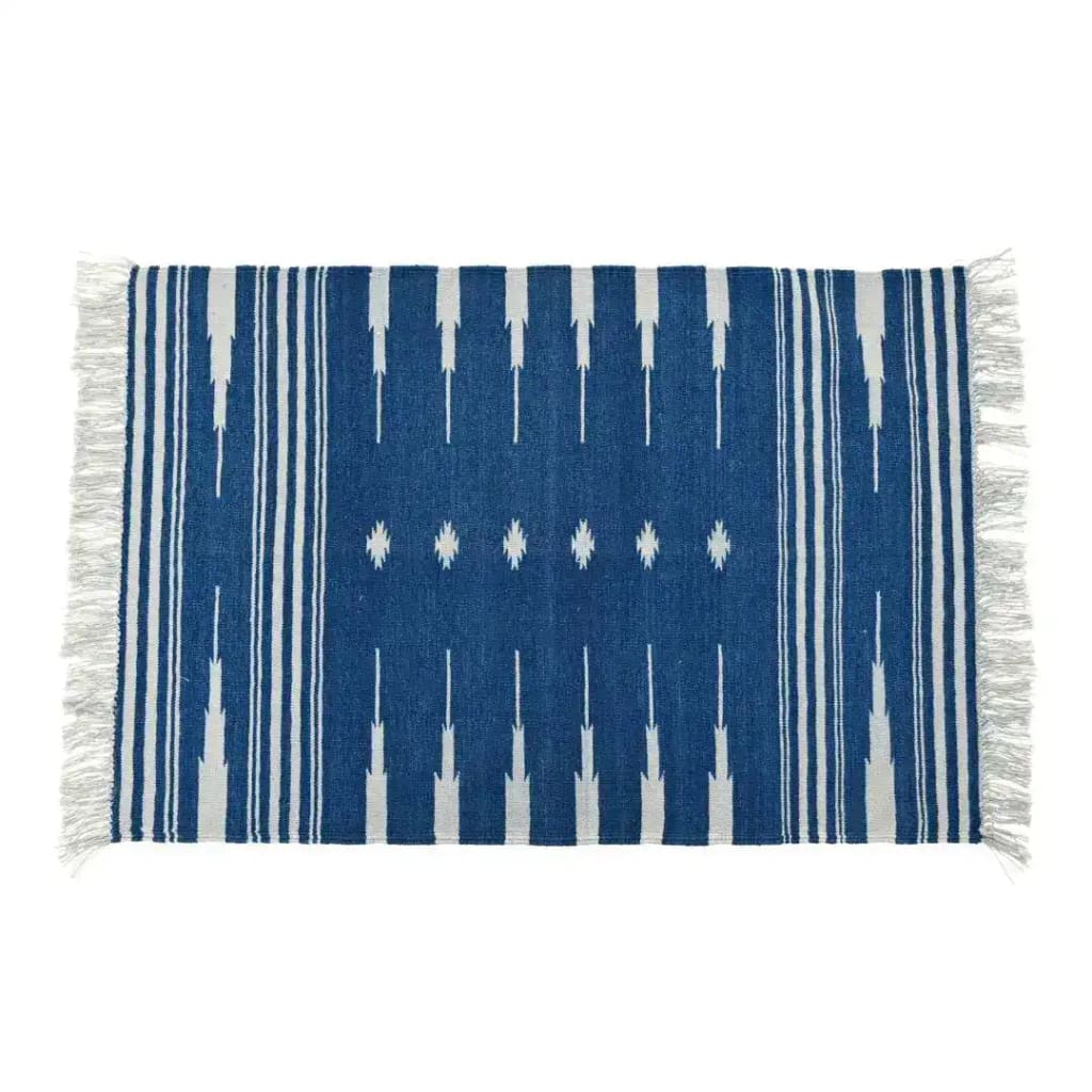 Handwoven dark blue and white patterned cotton rug with fringes, perfect as an area rug for boho-style living rooms. This large living room rug features intricate patterns and soft fringes, adding a cozy touch to any living room space.