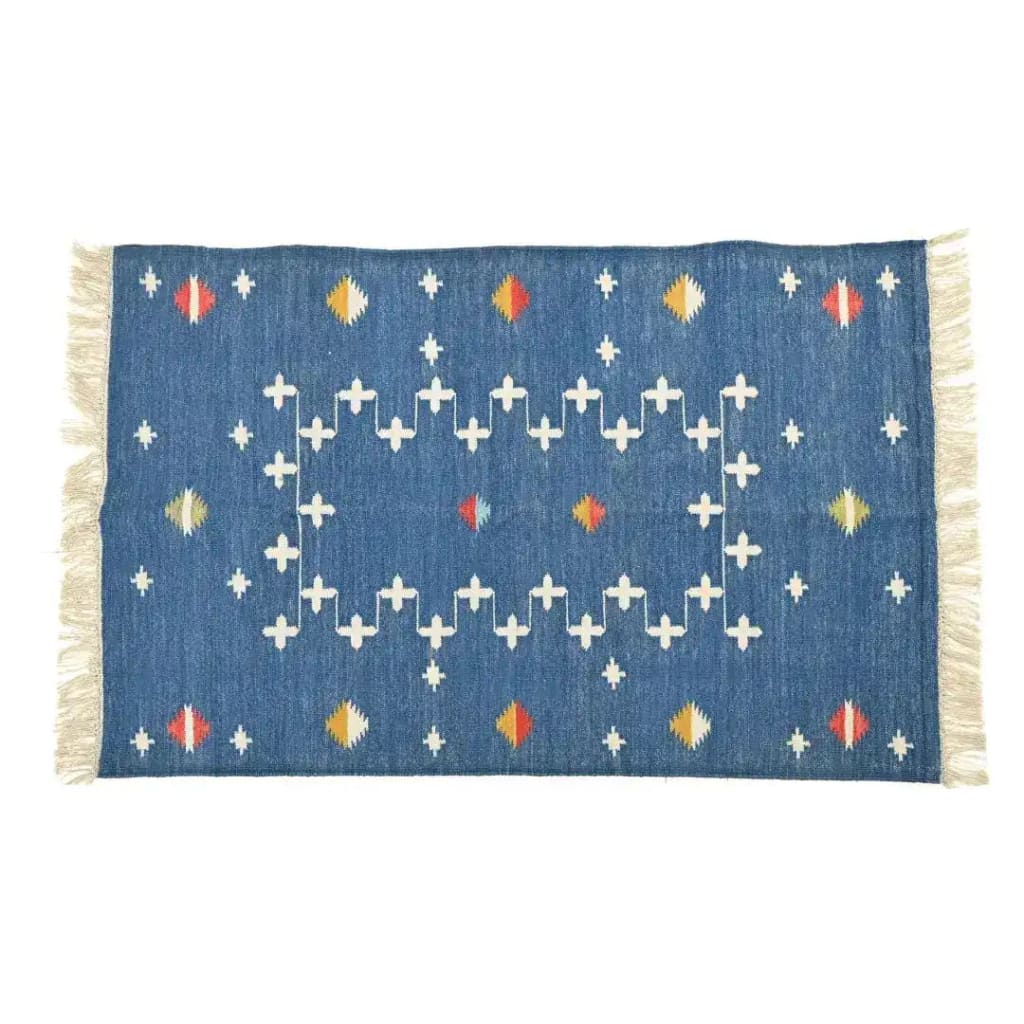 Handwoven dark cobalt blue patterned cotton area rug featuring a boho design with fringes, ideal for a bedroom or large living room. The intricate white patterns and vibrant accents make it a stylish addition to living room area rugs.