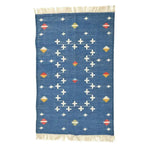 Handwoven dark cobalt blue cotton area rug featuring an intricate boho pattern with vibrant accents and fringes, ideal for enhancing a bedroom or large living room. Perfect for adding a touch of elegance to living room area rugs.