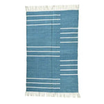 Handwoven denim blue and white minimalist cotton rug with fringes, perfect for large living rooms. This boho rug features a simple linear design, ideal for adding a touch of elegance to your living room rugs collection, especially in an 8x10 size.
