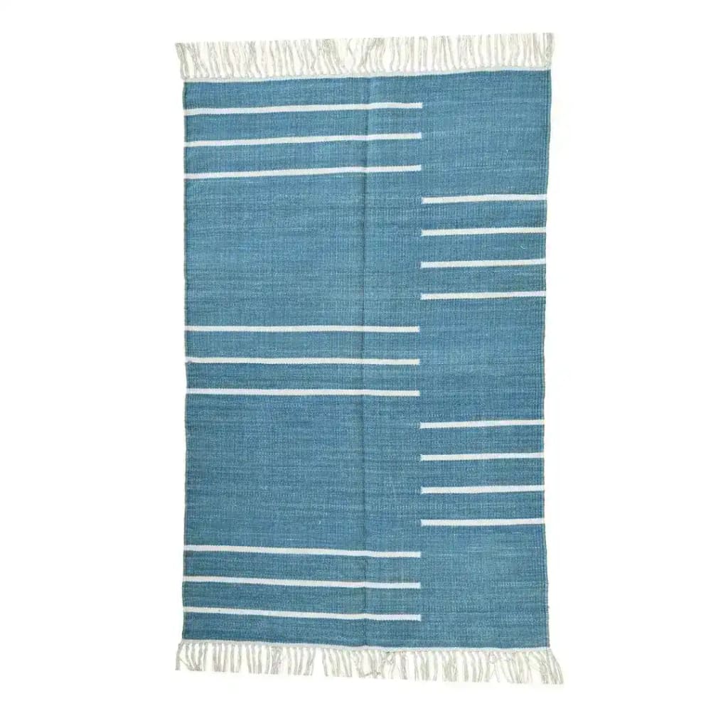 Handwoven denim blue and white minimalist cotton rug with fringes, perfect for large living rooms. This boho rug features a simple linear design, ideal for adding a touch of elegance to your living room rugs collection, especially in an 8x10 size.