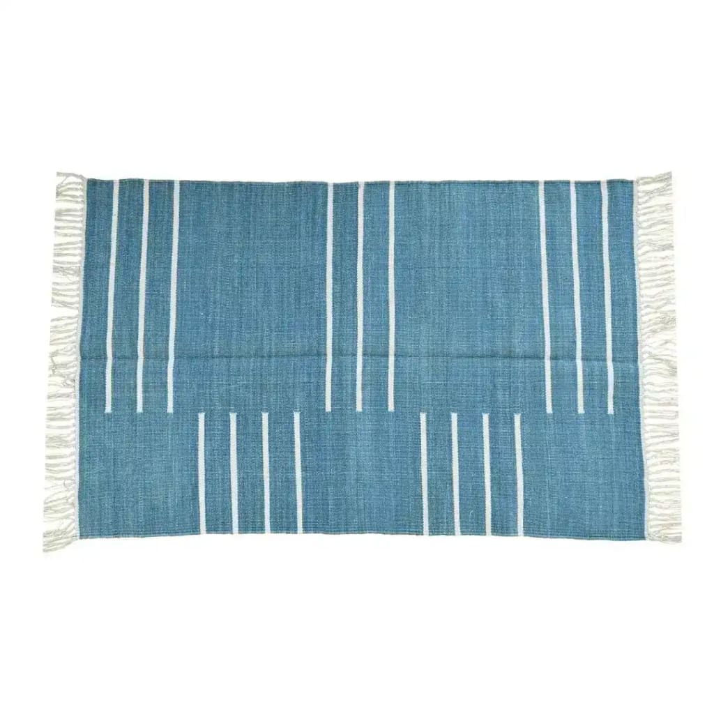 A stylish handwoven area rug in denim blue with minimalist white stripes and fringes, perfect for adding a boho touch to a living room. This cotton rug, ideal as a large living room rug or an 8x10 living room rug, combines elegance with simplicity.