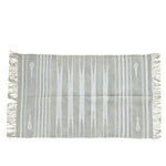 Handwoven gray and white stripe cotton area rug with fringes, perfect as a boho rug for a large living room. This 8x10 living room rug features a simple yet elegant design suitable for modern and cozy spaces.