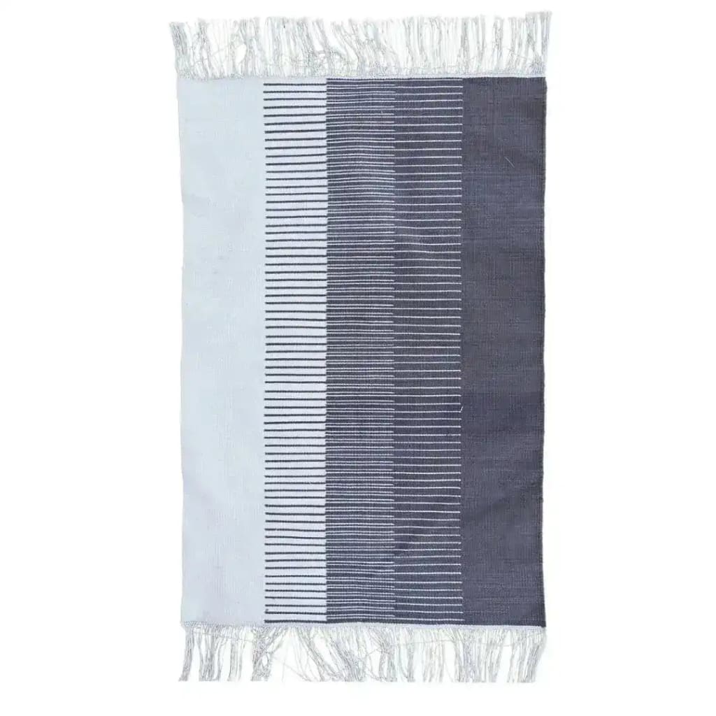 Handwoven gray ombre cotton rug featuring a gradient design with fringes, perfect as a large area rug for a boho-themed living room.