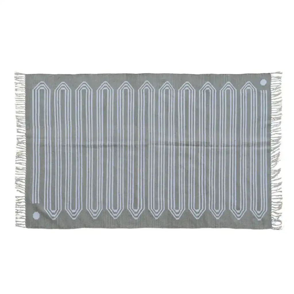 A handwoven gray cotton rug with snake-inspired patterns, featuring elegant fringes on the edges. This area rug is perfect for adding a boho touch to large living rooms. The design is ideal for spaces needing an 8x10 living room rug.