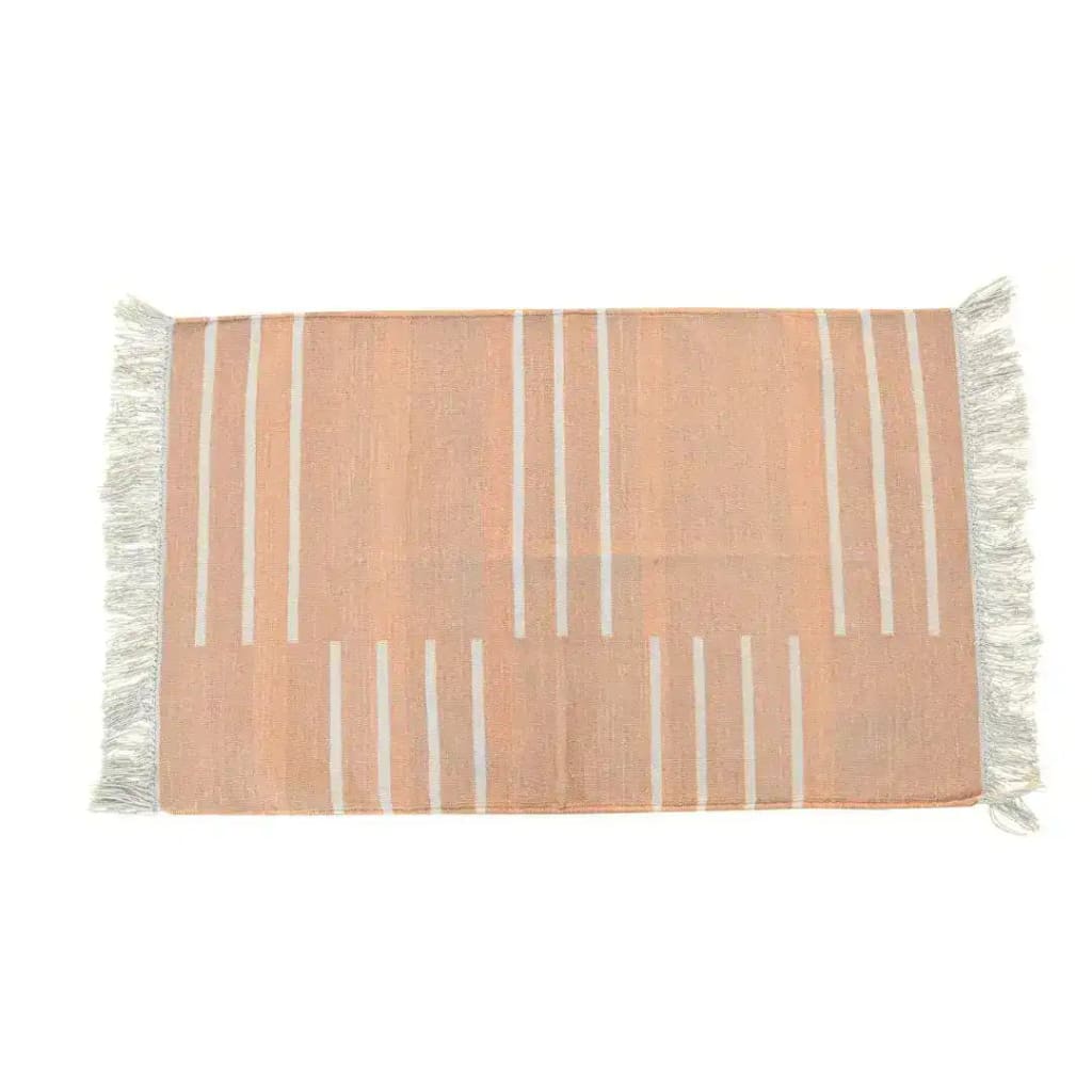 Handwoven light peach and white minimalistic cotton rug with fringes, perfect for adding a touch of boho style to your living room. This area rug features subtle stripes, ideal for those seeking area rugs for living room that are both stylish and functional.