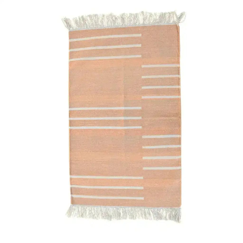 Handwoven light peach and white minimalistic cotton area rug with fringes, perfect for adding a boho touch to your living room. This elegant rug features subtle horizontal stripes and is ideal for those seeking area rugs for living room decor.