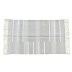 A handwoven minimalistic gray cotton area rug featuring fringes on both ends. This large living room rug, sized 8x10, showcases a subtle striped pattern, perfect for adding a boho touch to any living room decor.