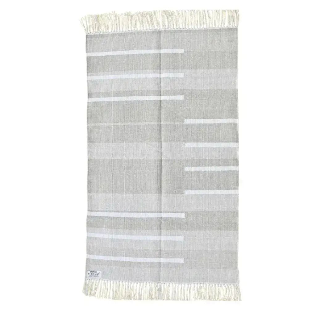 Handwoven minimalistic gray cotton area rug with fringes, perfect for large living rooms. This boho rug features a subtle pattern, ideal for living room rugs 8x10.