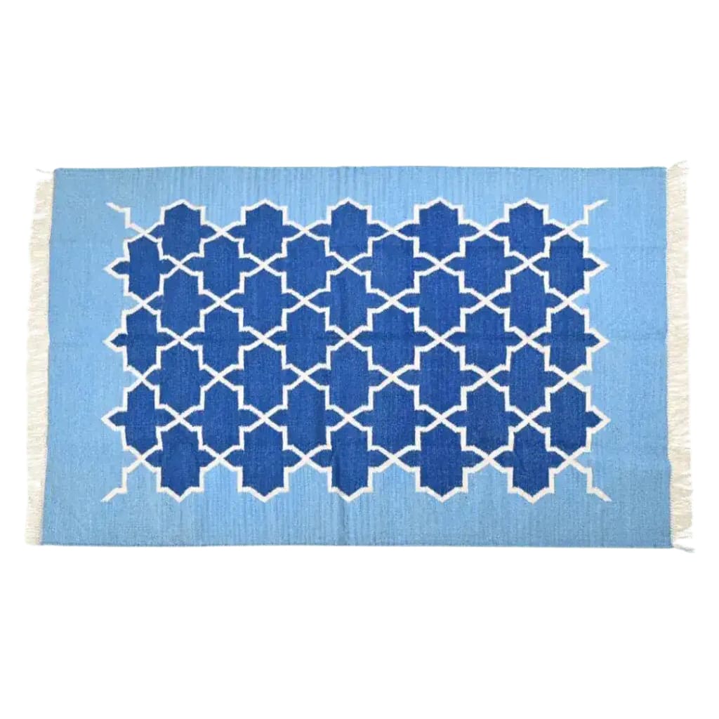 Top view of a handwoven Moroccan blue tiles cotton rug with fringes, showcasing intricate geometric patterns in rich blue hues. Perfect as a centerpiece in large living rooms, this 8x10 boho rug adds a touch of elegance and comfort to any living space.
