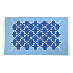 Top view of a handwoven Moroccan blue tiles cotton rug with fringes, showcasing intricate geometric patterns in rich blue hues. Perfect as a centerpiece in large living rooms, this 8x10 boho rug adds a touch of elegance and comfort to any living space.