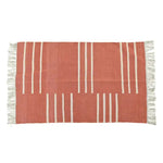 Handwoven orange and white minimalistic cotton area rug with fringes, perfect for a dining room or office. The boho rug features a simple geometric pattern, ideal as a dining table rug or office rug.