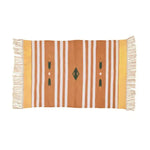 Handwoven orange and white patterned cotton area rug with fringes, perfect for adding a boho touch to your office or bedroom. The rug features a striking geometric design, ideal for use as bedroom rugs or rugs for office spaces.