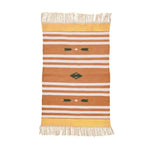 A handwoven orange and white patterned cotton area rug with fringes, perfect for adding a boho touch to your office or bedroom space. This stylish rug features intricate designs and is ideal for use as a bedroom rug or a decorative piece in a modern office.