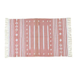 Handwoven peach and white patterned cotton area rug with fringes, perfect for a boho theme in dining rooms or large living rooms. This elegant rug features intricate geometric designs that add a touch of sophistication to any living space.