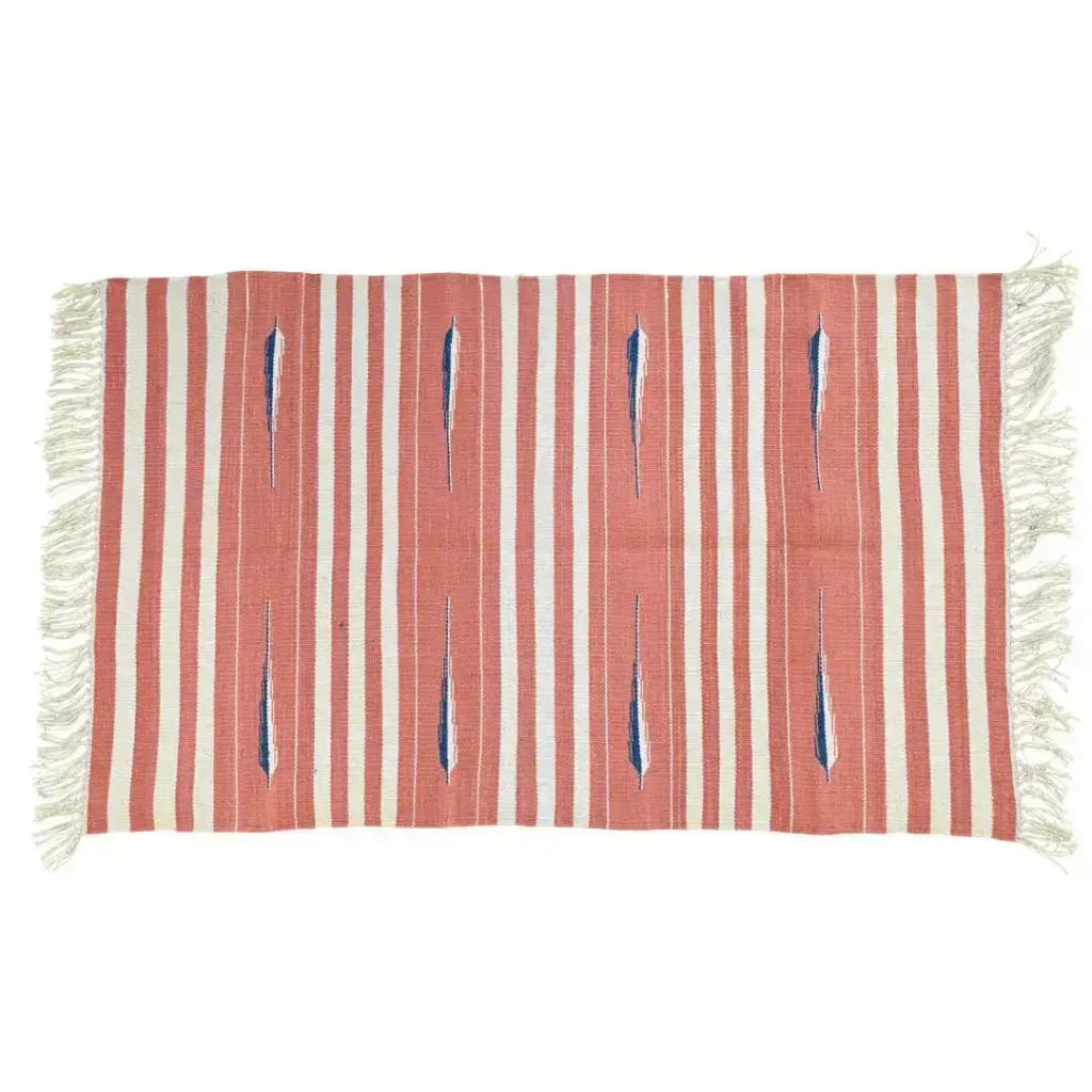 A handwoven peach and white tear drop cotton rug with fringes, ideal for a boho-themed living room. The large area rug features a striped pattern, making it a perfect addition to any large living room space.