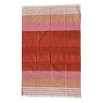 A vibrant handwoven red ombre cotton area rug featuring soft fringes at the edges. This boho rug is perfect for adding a touch of warmth and style to any dining room or living room. The gradient design showcases a beautiful blend of red, pink, and beige tones, making it an ideal choice for those seeking area rugs for living room spaces.