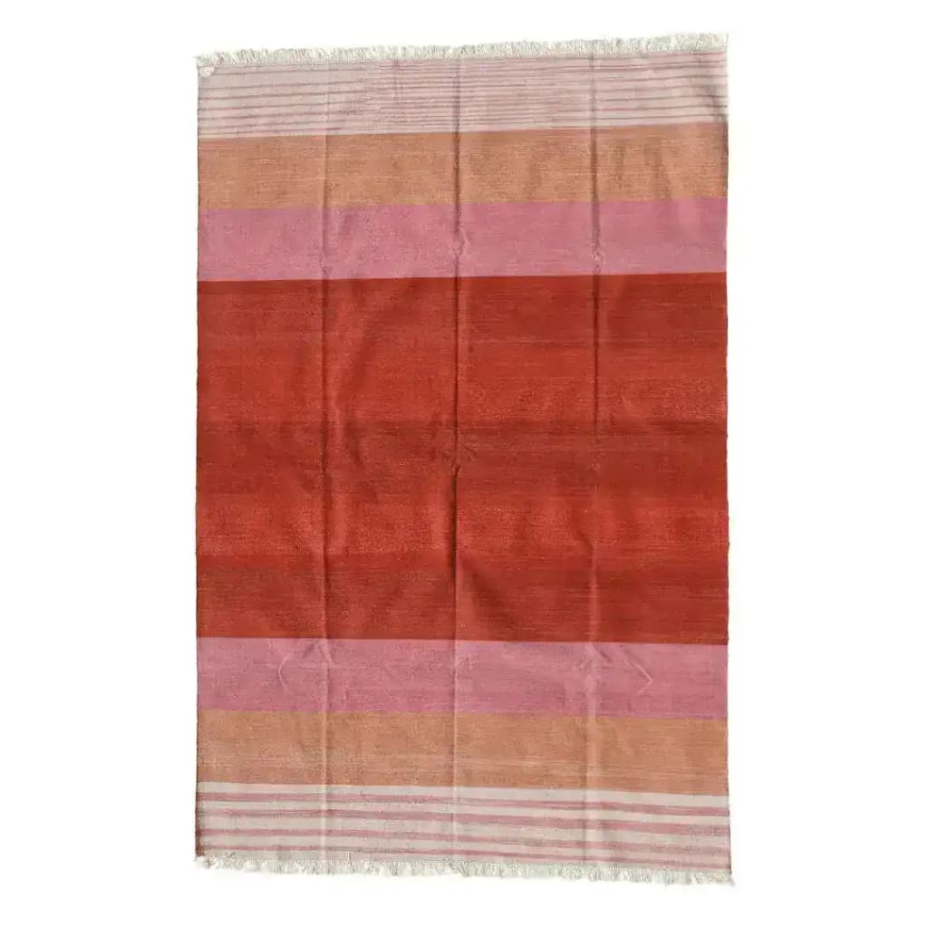 A vibrant handwoven red ombre cotton area rug featuring soft fringes at the edges. This boho rug is perfect for adding a touch of warmth and style to any dining room or living room. The gradient design showcases a beautiful blend of red, pink, and beige tones, making it an ideal choice for those seeking area rugs for living room spaces.