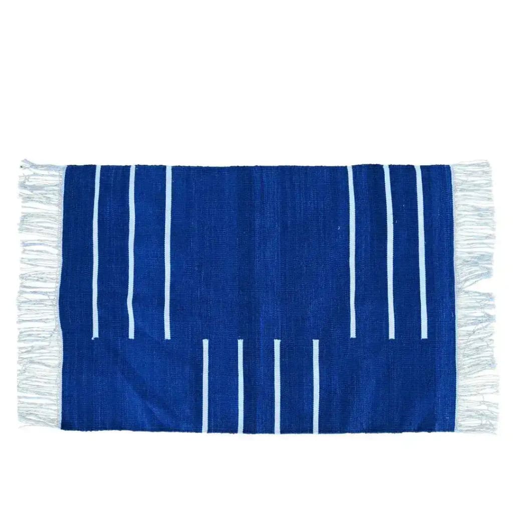 Handwoven royal blue and white minimalistic cotton area rug with fringes, perfect for adding a boho touch to a dining room or office. The rug features a simple and elegant pattern, making it an ideal choice for those seeking stylish cotton rugs or rugs for office spaces.