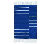 A handwoven royal blue and white minimalistic cotton area rug featuring a simple striped pattern and fringed edges. Ideal for adding a touch of elegance to a dining room or office, this boho rug combines style with the comfort of cotton, making it a perfect choice for rugs in an office setting.