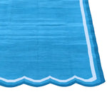 A beautifully handwoven scalloped cotton area rug in blue and white, perfect for adding a touch of vintage charm to your bedroom. The large boho rug features intricate patterns and soft textures, making it an ideal choice for bedroom area rugs and enhancing the cozy ambiance of your space.