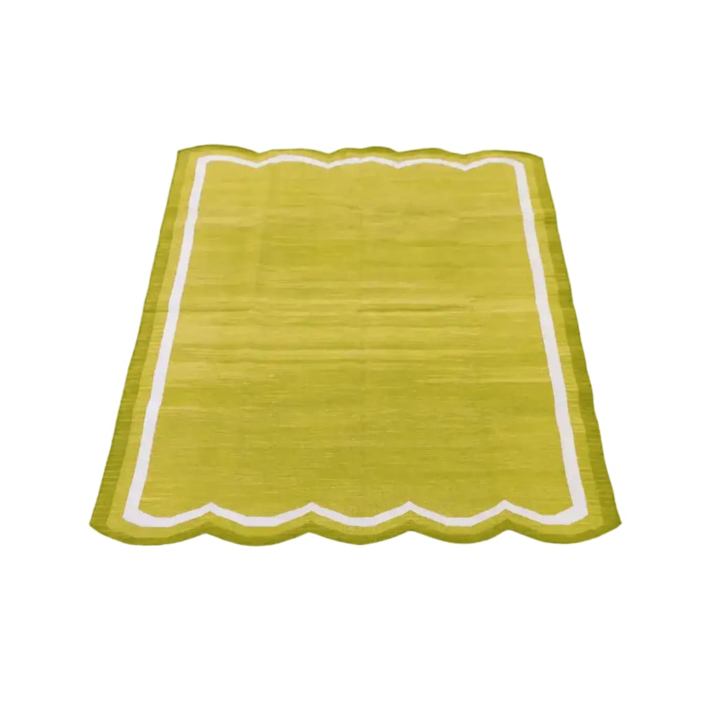 A vibrant lime green handwoven scalloped cotton area rug with a white border, perfect for adding a touch of vintage charm to your living room or office. This boho rug complements modern decor as well as classic styles, making it an ideal choice for those seeking stylish rugs for living rooms or offices.