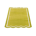 A vibrant lime green handwoven scalloped cotton area rug with a white border, perfect for adding a touch of vintage charm to your living room or office. This boho rug complements modern decor as well as classic styles, making it an ideal choice for those seeking stylish rugs for living rooms or offices.