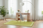 Modern home office with a desk, chair, and green rug.