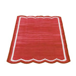 Handwoven scalloped cotton area rug in vibrant red, ideal for a vintage or boho-inspired dining room or office. This elegant cotton rug features a unique scalloped edge, making it a perfect addition to formal dining room settings or as a striking dining room carpet.