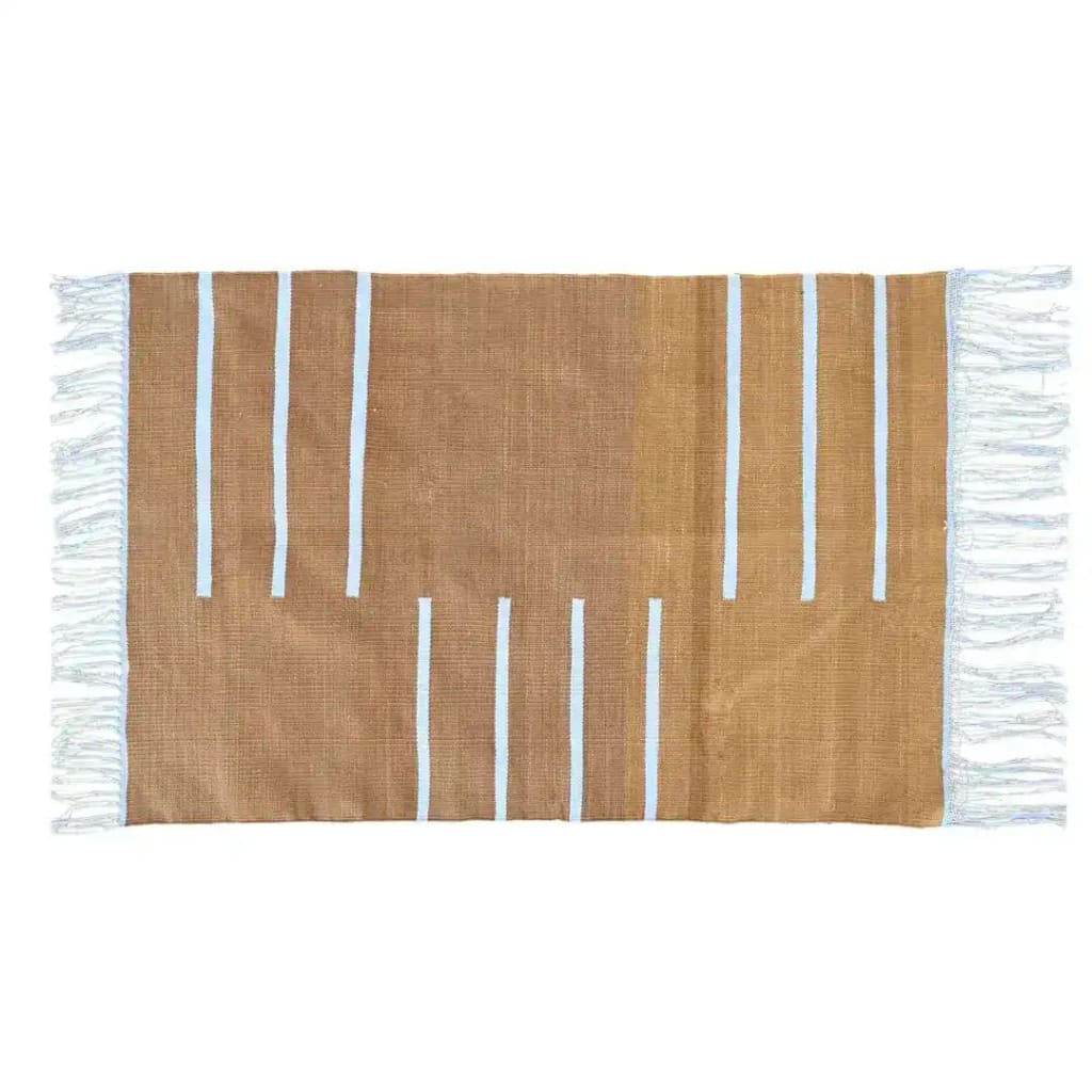 A handwoven turmeric and white minimalistic cotton area rug with fringes, ideal for large living rooms. This boho rug adds a touch of elegance with its simple design and fringe details, perfect as a large area rug or for those seeking stylish cotton rugs.