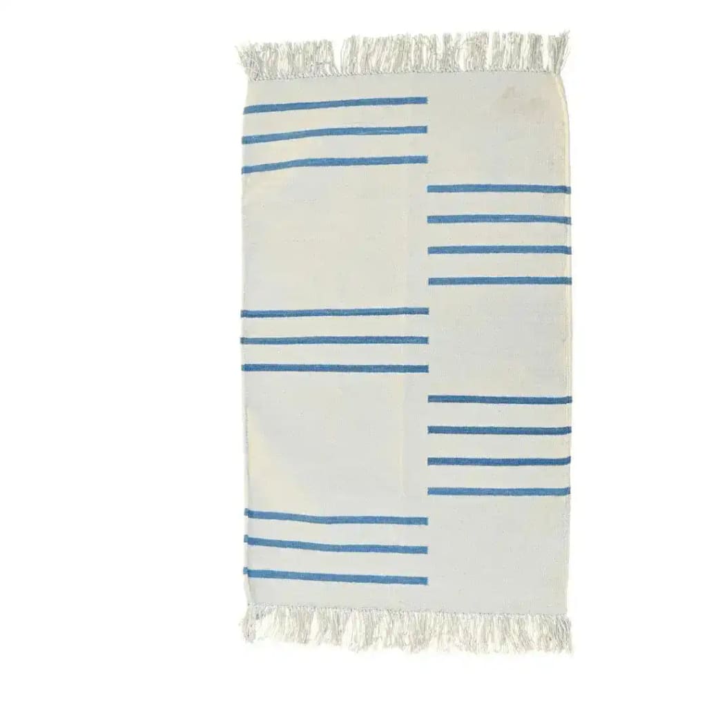 A handwoven white and blue minimalistic cotton area rug with fringes, perfect for adding a boho touch to your bedroom or living room. This elegant rug features simple blue stripes on a white background, creating a stylish and cozy atmosphere.