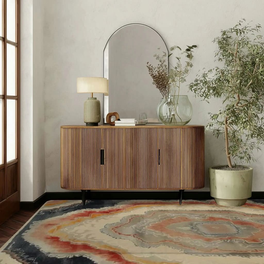 A contemporary area rug with an abstract design featuring earthy tones and intricate patterns, perfect for adding elegance to a living room. The Harmonious Haven Hand Knotted Area Rug complements the modern wooden sideboard and greenery, creating a welcoming and stylish space reminiscent of Persian rugs.