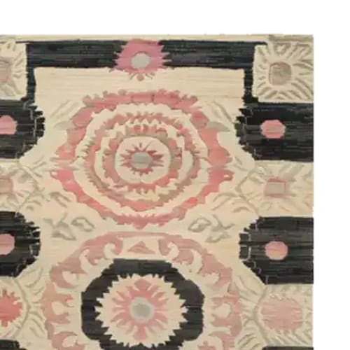 A beautifully designed Harmony Circles Hand Tufted Area Rug featuring intricate circular patterns in shades of pink and black. This vintage wool rug adds a touch of elegance, perfect for dining rooms or office spaces, complementing your dining table setup with its artistic flair.