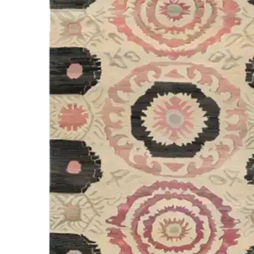 The Harmony Circles Hand Tufted Rug showcases a vintage design with intricate circular patterns in warm, earthy tones. This area rug, perfect for a dining room or office, adds a touch of elegance and sophistication with its wool construction, making it a standout dining table rug.